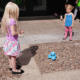 Girls playing with Dash the robot