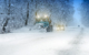 Image shows a city snowplow plowing a snowy street.