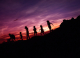 Group of children walking home at sunset.